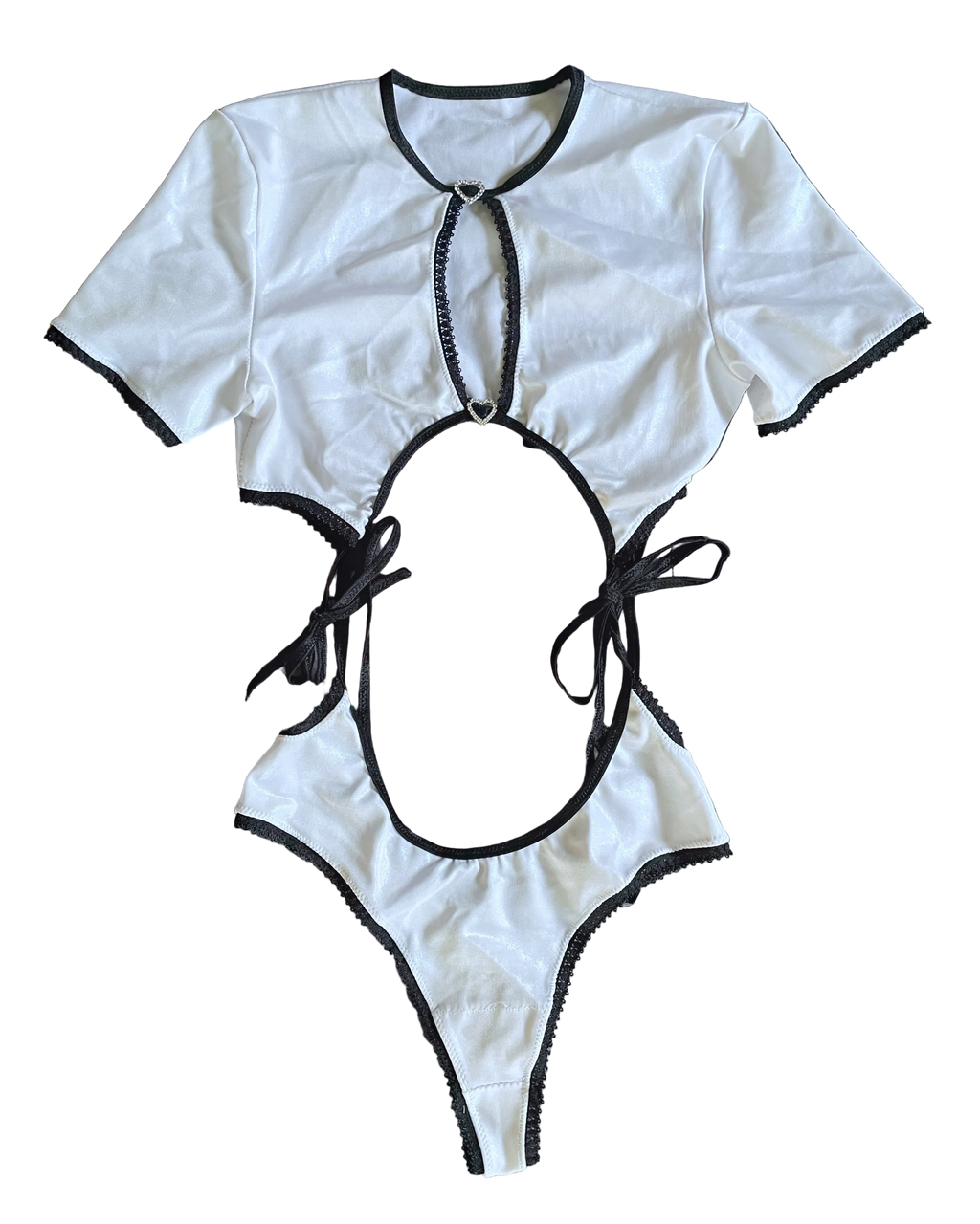 White two piece set with black accent trim and rhinestone buckles on a white background
